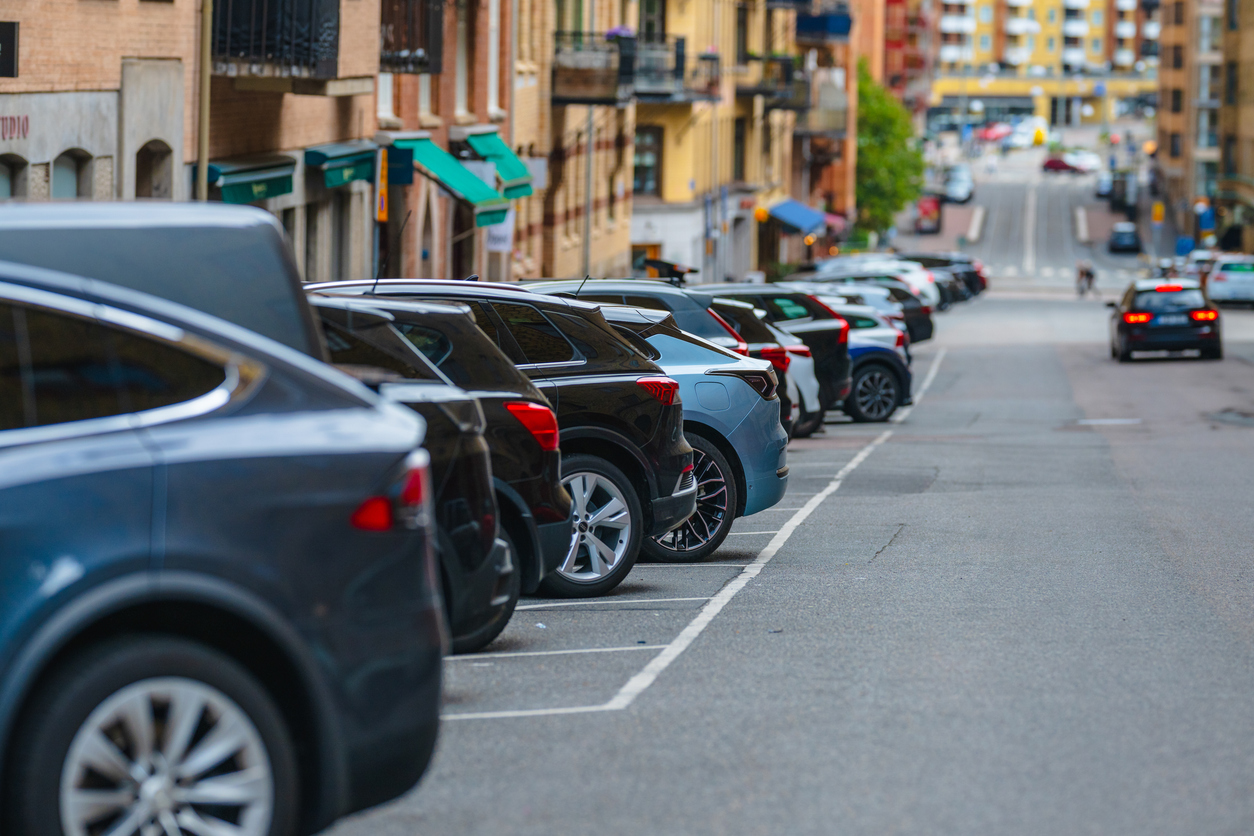 Row of parked cars along urban city street